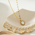 HAMMELA Or : collier pendentif avec perle centrale et halo de cristaux